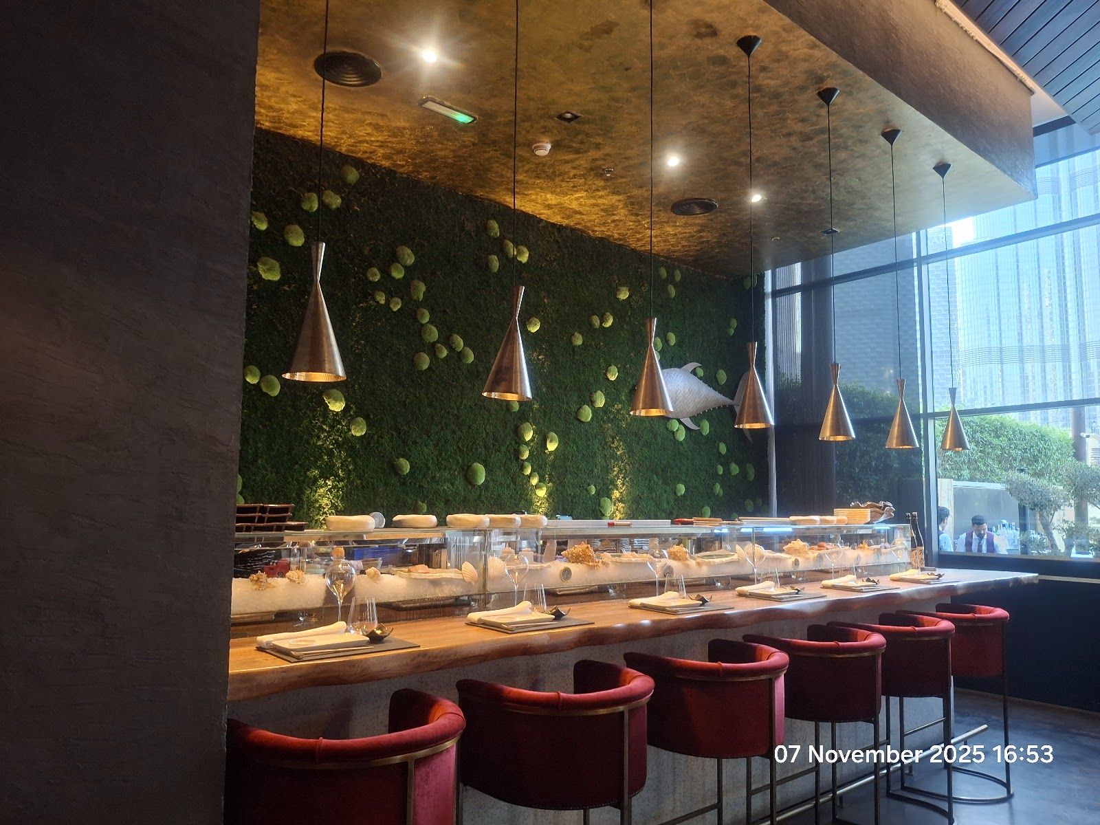99 Sushi Bar Dubai omakase counter &mdash; chef preparing nigiri at the 8-seat counter