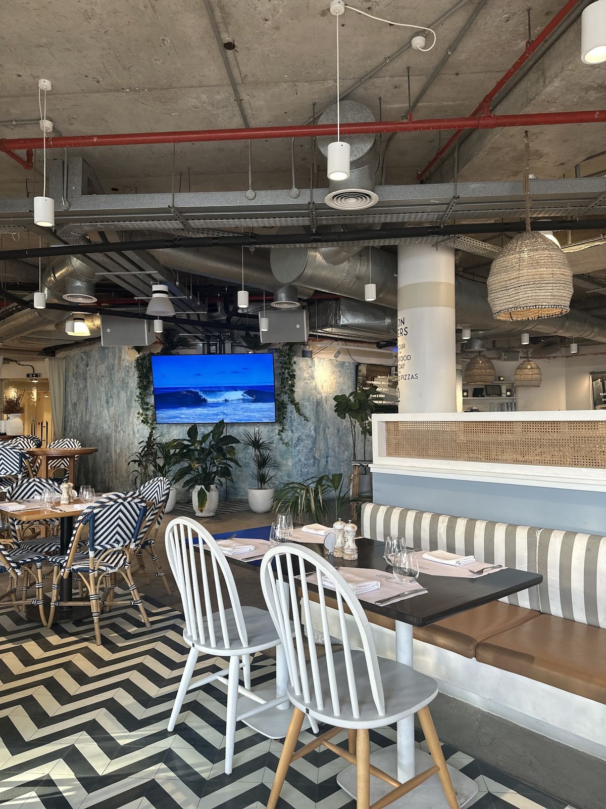 Byron Bathers Club Dubai — beachfront seating and palm-fringed setting