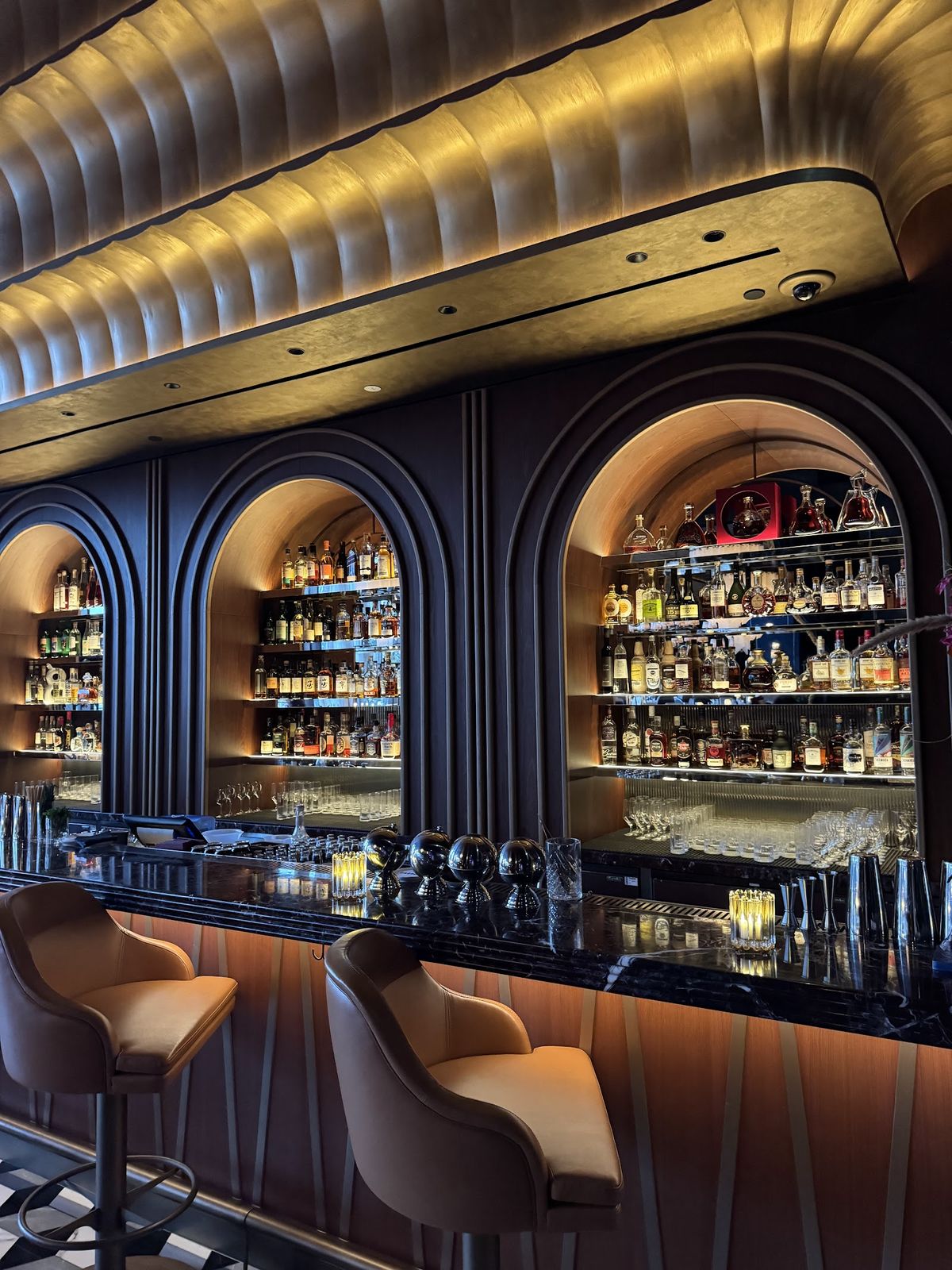 Carbone Dubai late seating — DIFC dining room with rich red booths and waiters in dinner jackets