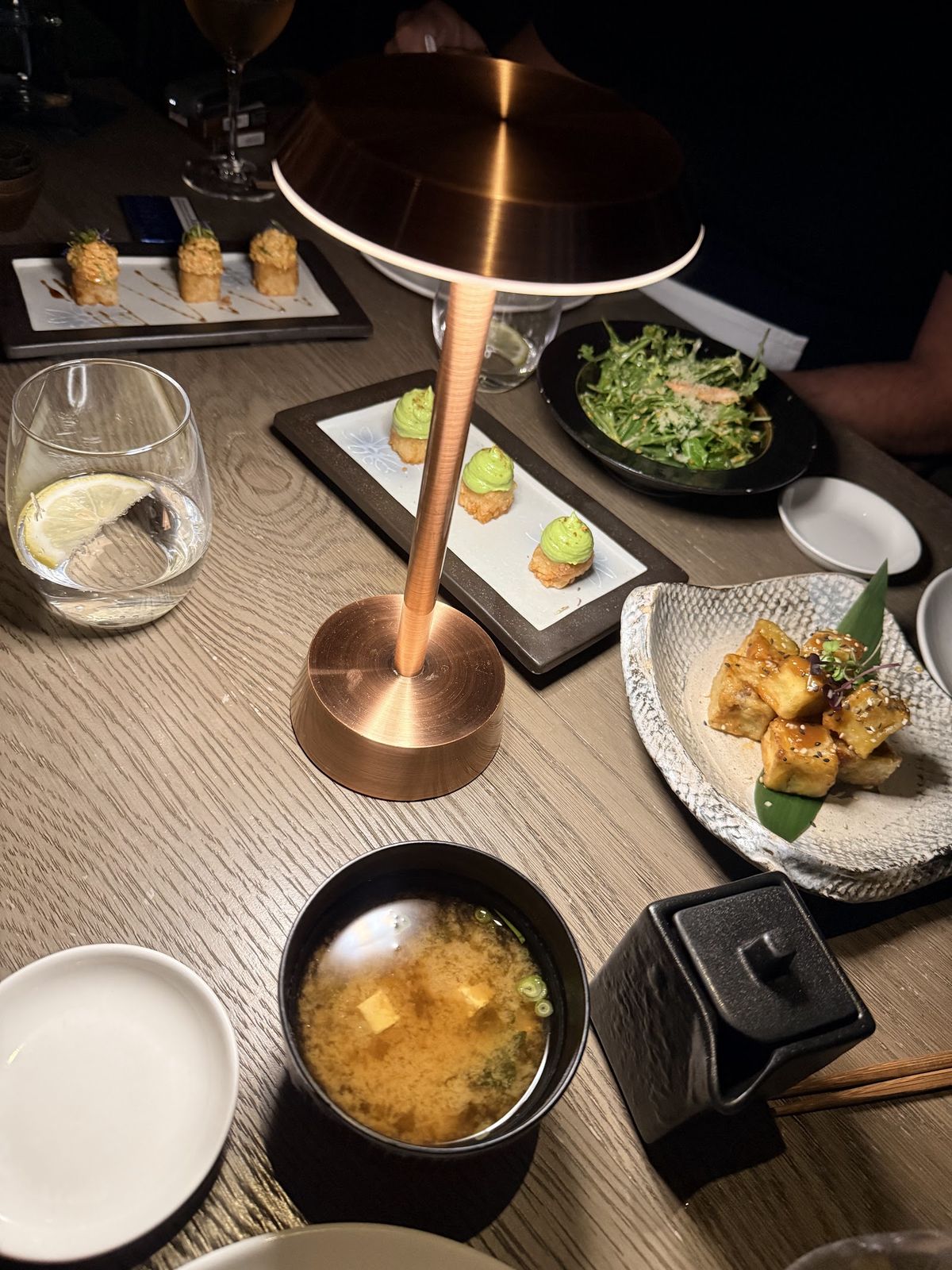 Clap Dubai — sushi counter seating with skyline backdrop