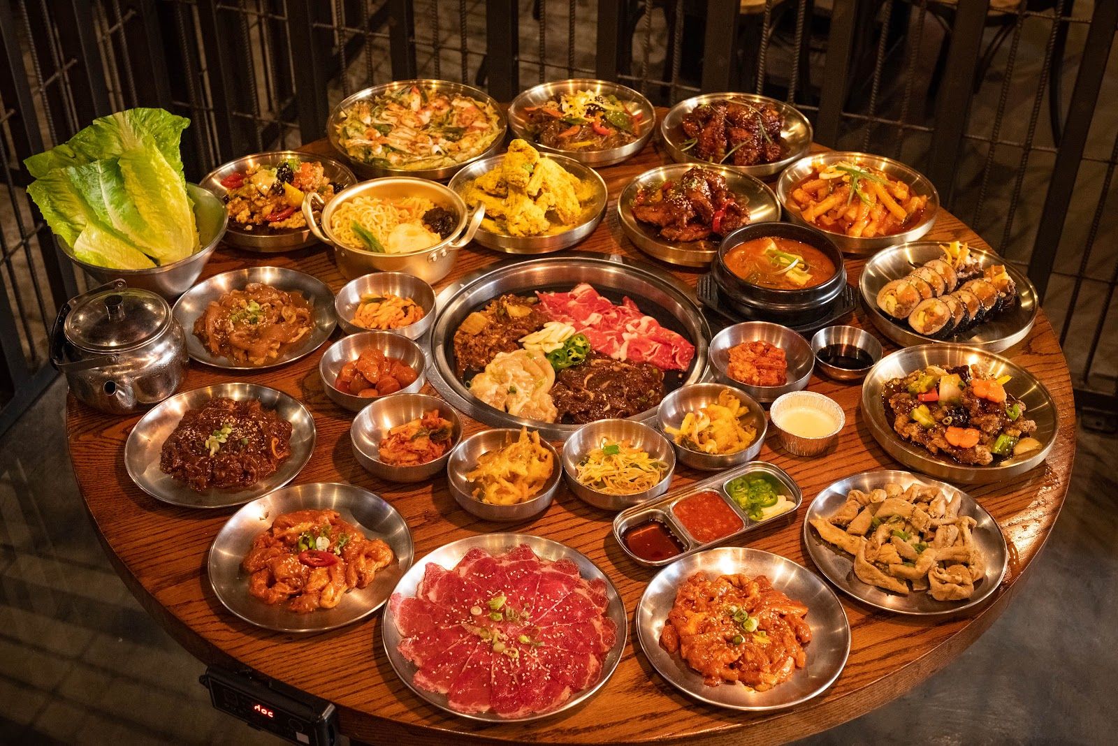 Korean BBQ table grill setup with banchan side dishes Dubai