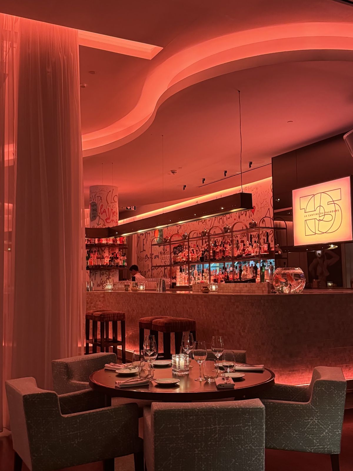 La Cantine du Faubourg Dubai — moody dining room with projection walls