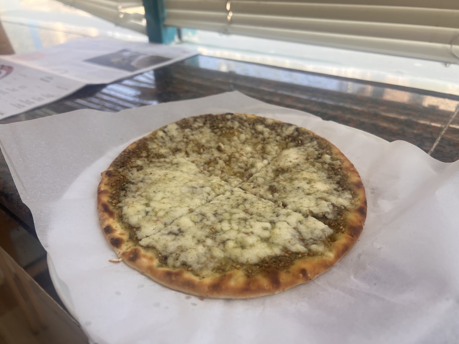 Manakish Express Satwa Dubai — zaatar manousheh coming out of the oven