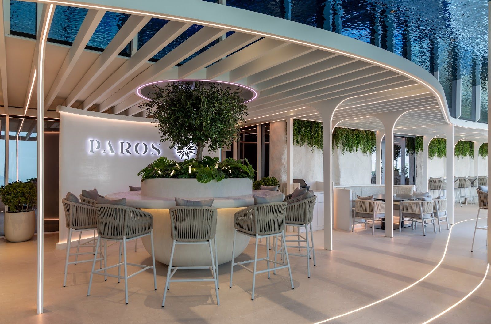 Greek island-style restaurant with white furniture and azure pool views on Palm Jumeirah Dubai