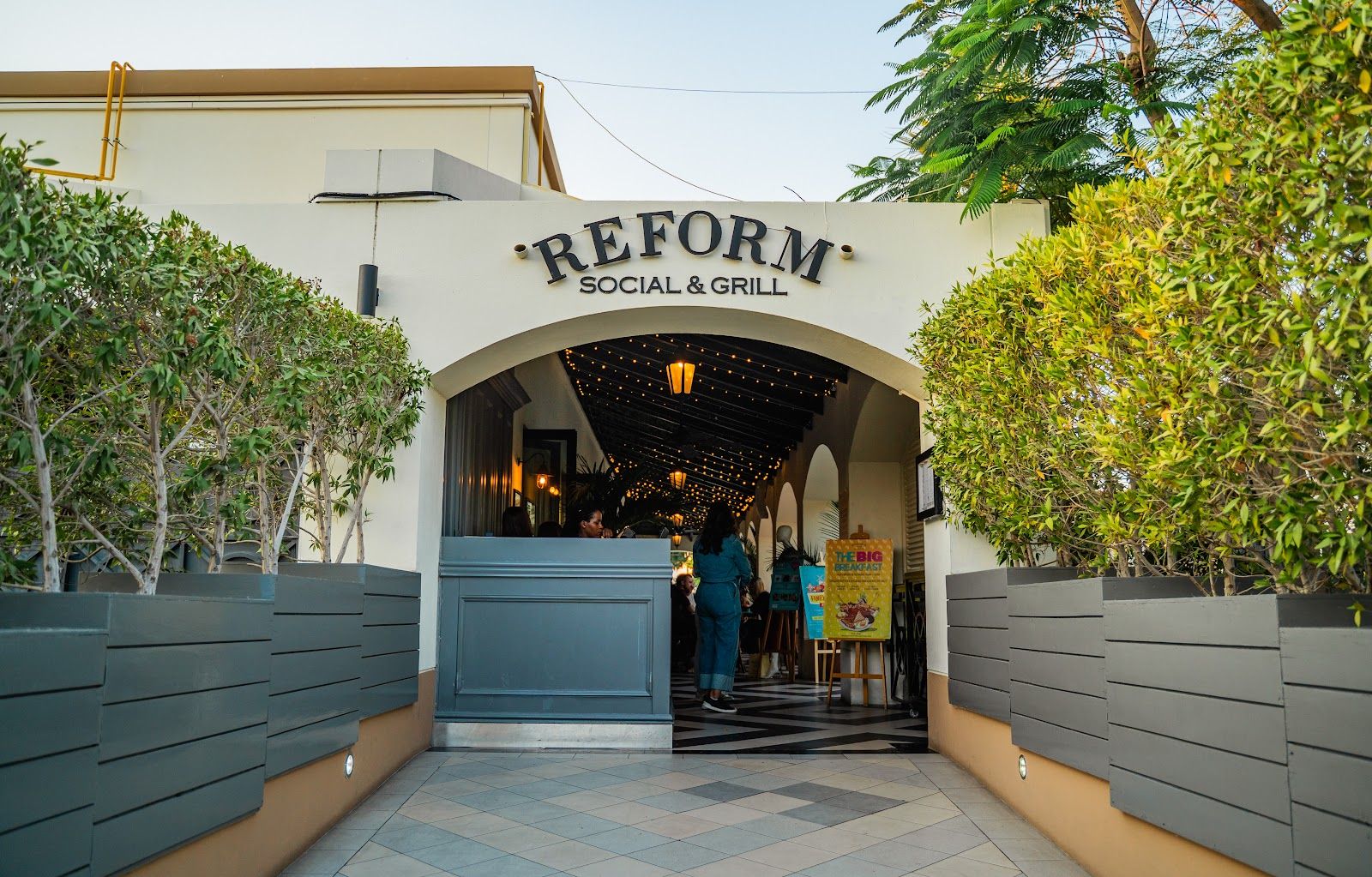 Reform Social & Grill Dubai — outdoor terrace with garden and play area in The Meadows