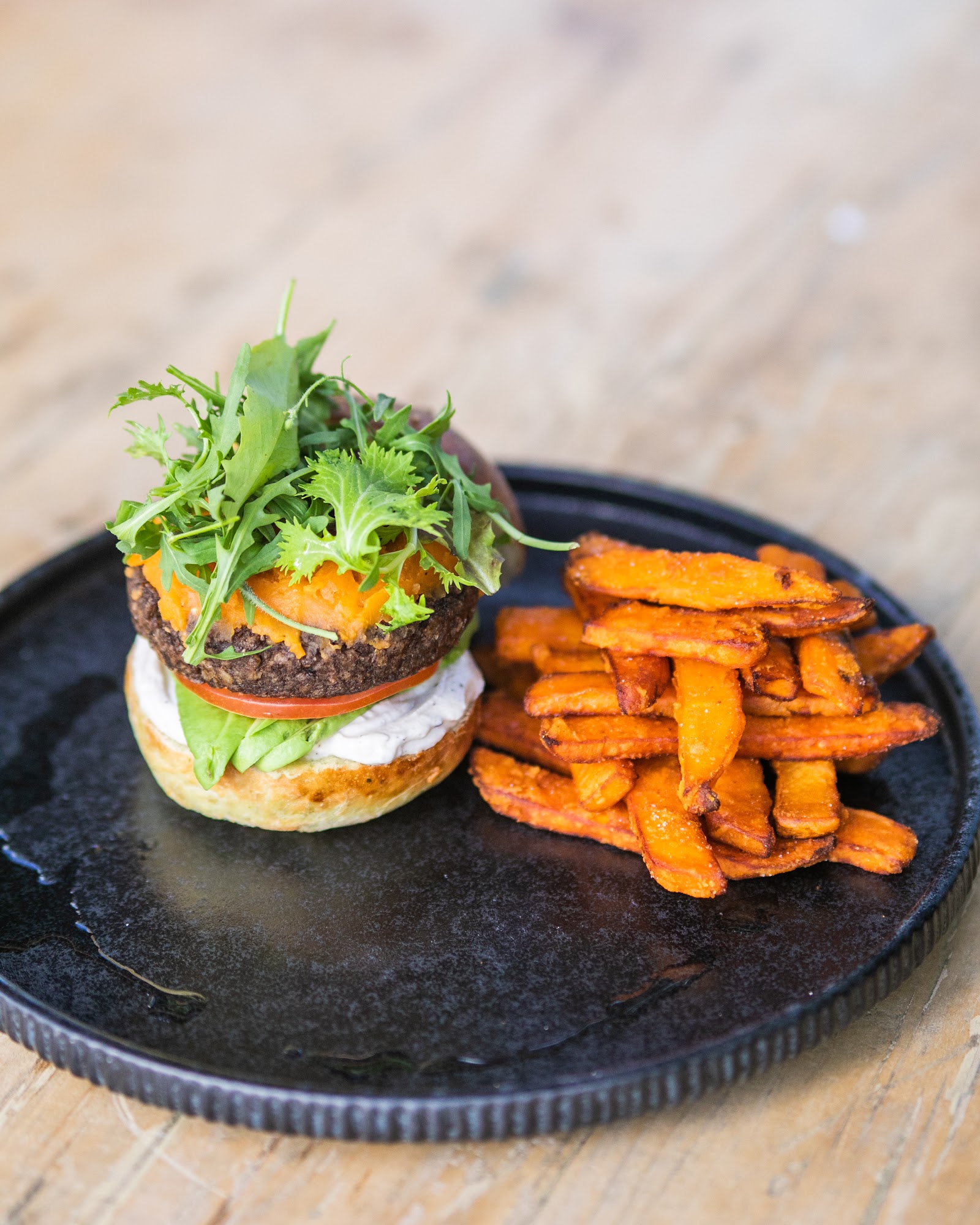 Sanderson's Cafe Sustainable City Dubai — café tables on the plaza in Diamond Plaza block